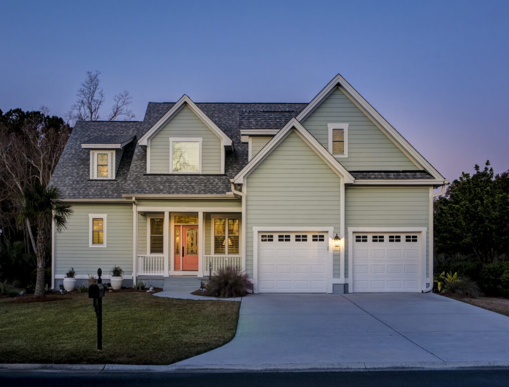 Front elevation of beautiful home lit up at twilight.